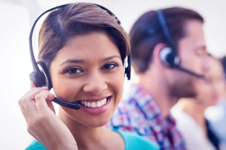 Credit bureau customer service representatives on the phone assisting customers in an office.