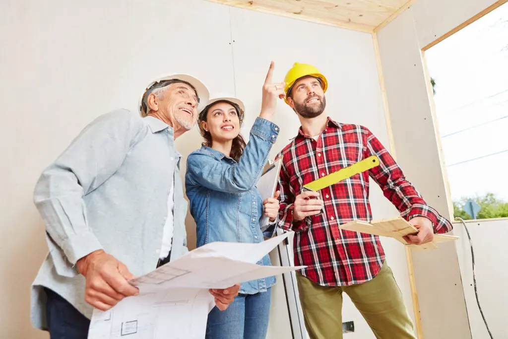 Personal Loans for Home Addition Projects A homeowner and construction crew reviewing the progress of a residential home addition.