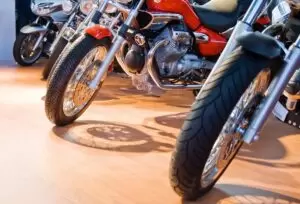 Front wheel of several motorcycles aligned for sale.