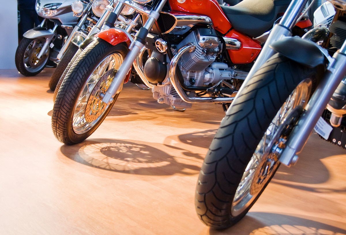 Front wheel of several motorcycles aligned for sale.