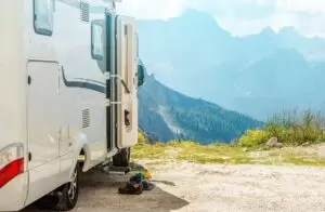 Motorhome RV on dirt roads camping in mountains.
