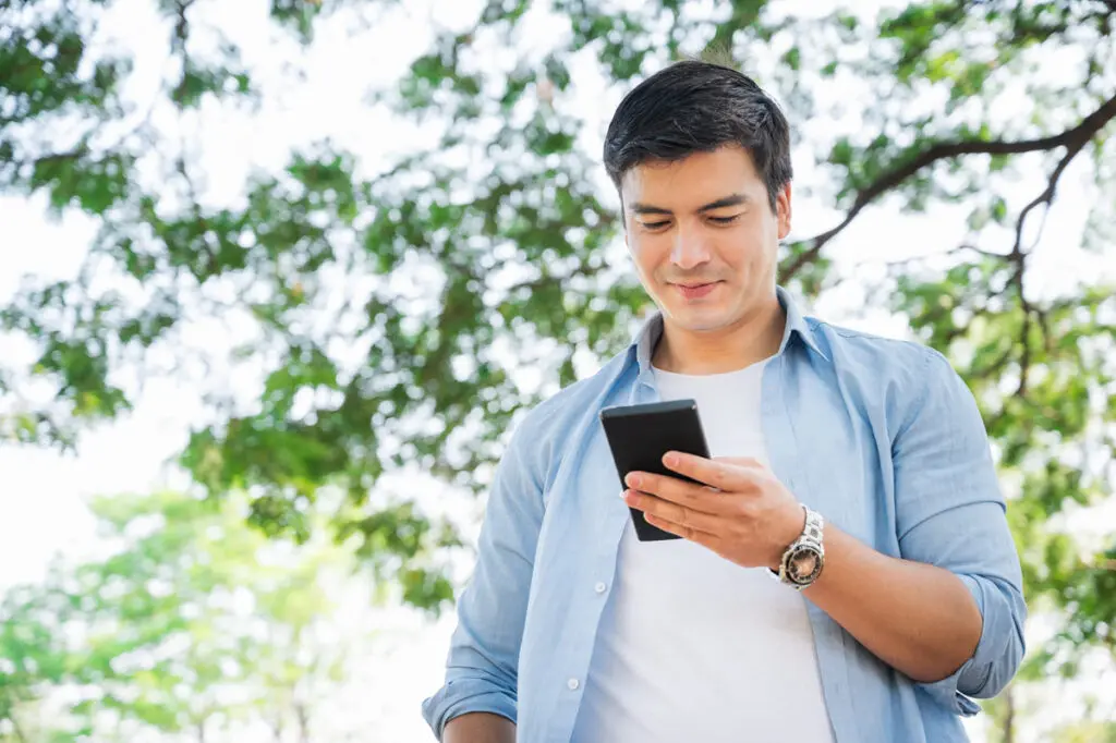 Comparing Top $10,000 Personal Loans A person using a smartphone to compare top $10,000 personal loan offers.