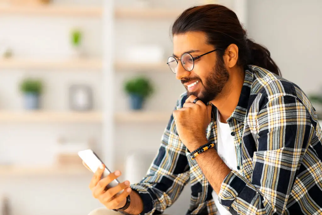 Comparing Top $2,000 Personal Loans A person using a smartphone to compare top $2,000 personal loan offers.