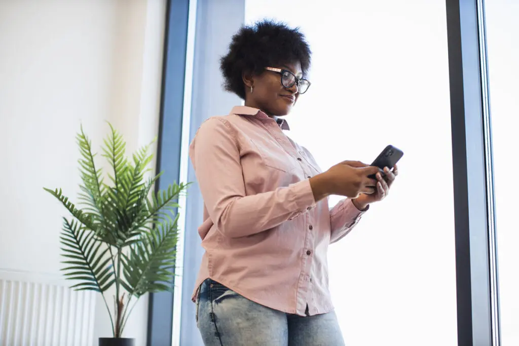 Comparing Top $2,500 Personal Loans A person using a smartphone to compare top $2,500 personal loan offers.