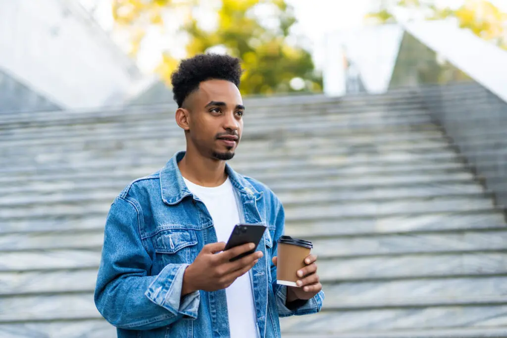 A person using a smartphone to compare top $4,000 personal loan offers.