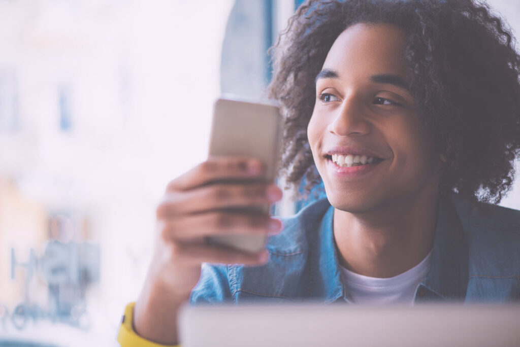 Comparing Top $500 Personal Loans A person using a smartphone to compare top $500 personal loan offers.