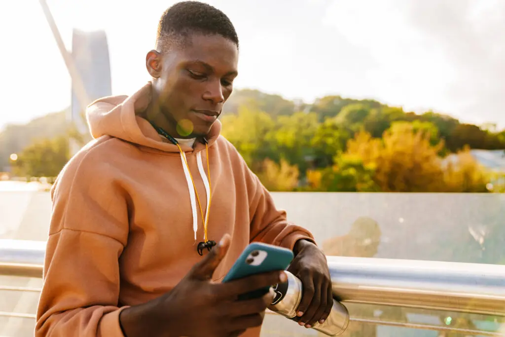 A person using a smartphone to compare top $7,000 personal loan offers.