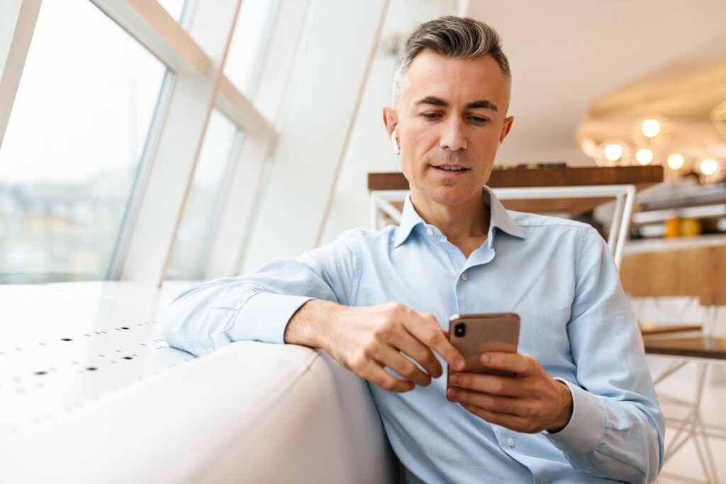 Comparing Top $75,000 Personal Loans A person using a smartphone to compare top $75,000 personal loan offers.
