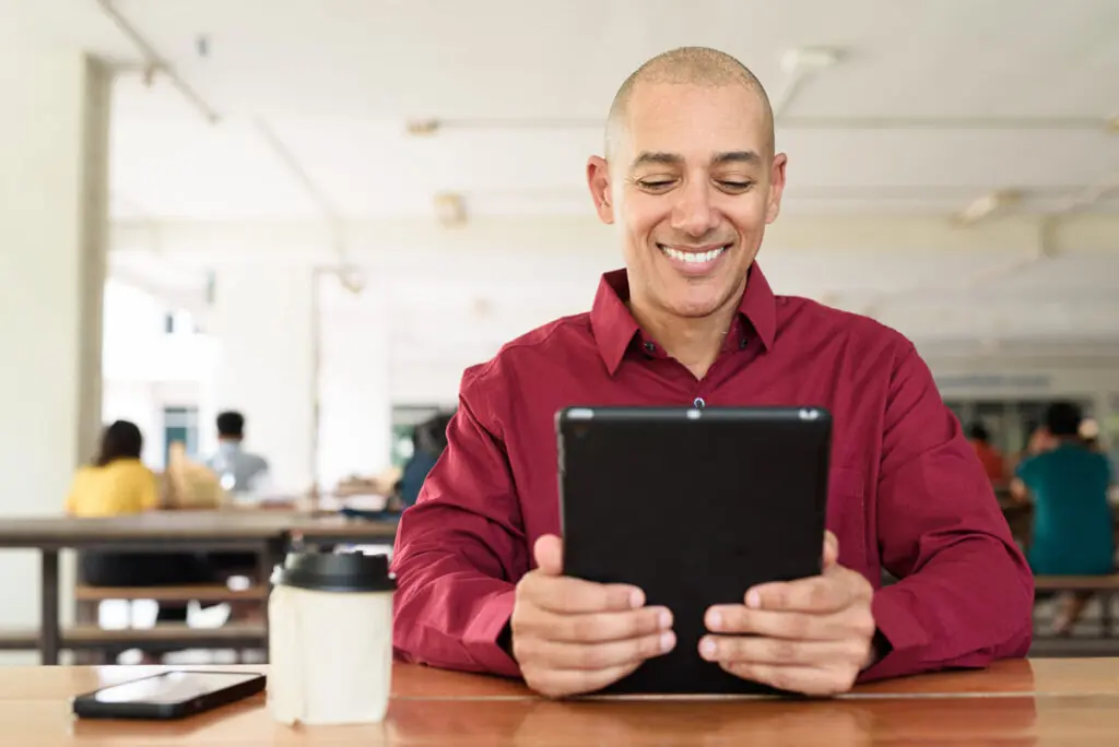 Comparing Excellent Credit Personal Loans A person using a tablet to compare excellent-credit personal loan offers in the 800–850 range.
