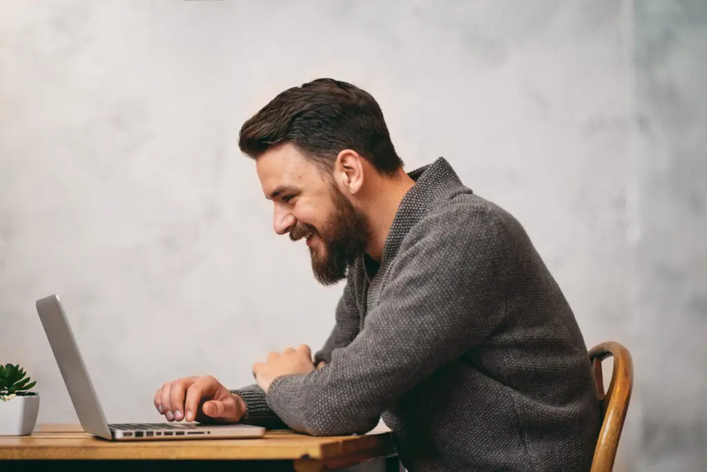 Comparing Top $8,000 Personal Loans A person using a laptop to compare top $8,000 personal loan offers.