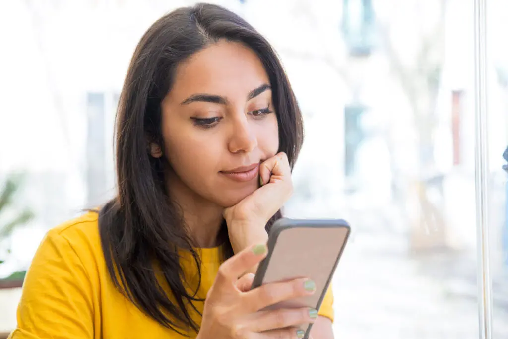 Comparing Top $9,000 Personal Loans A person using a smartphone to compare top $9,000 personal loan offers.