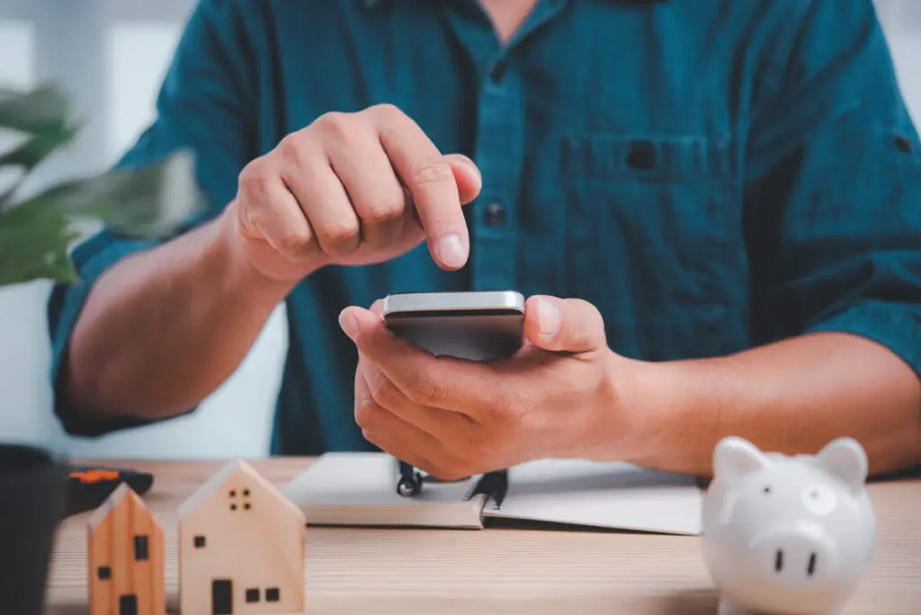 A person using a smartphone to compare low APR personal loan offers.