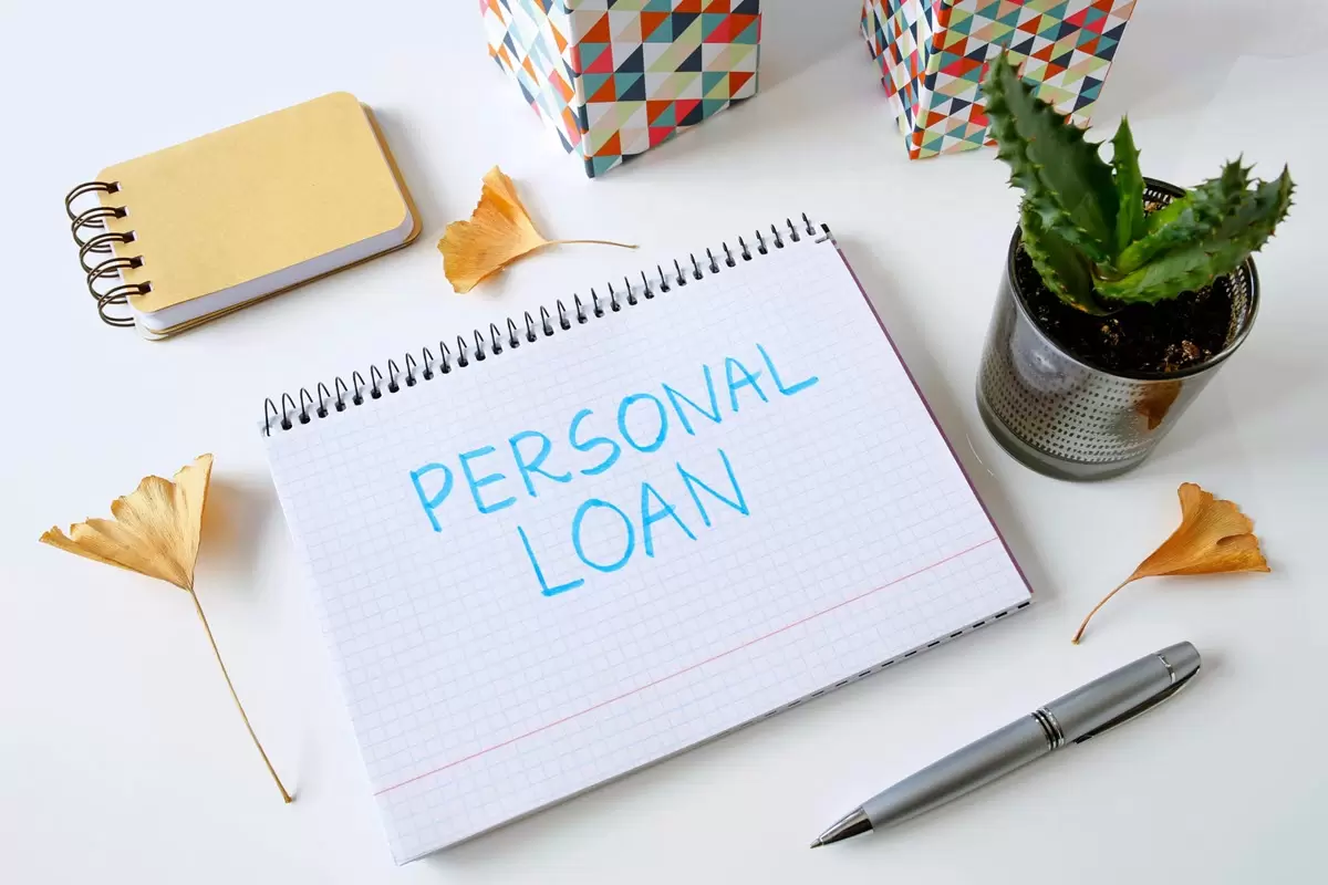 Personal loan written in notebook on white desk. Personal loan written in notebook on white desk.