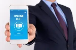 Professional holding out a smartphone displaying a finance app on the screen in a business setting.