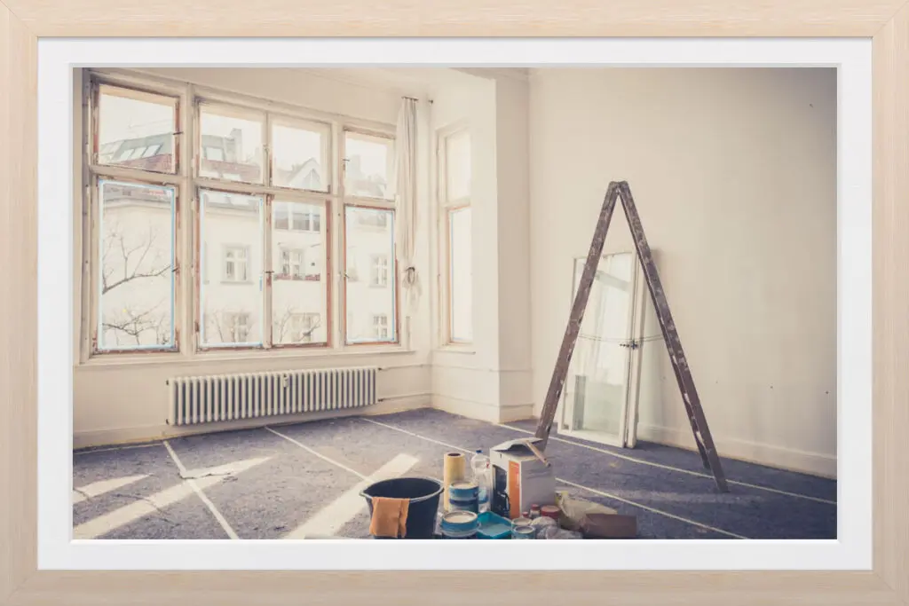 Framed photo of an unfinished living room during a DIY remodel.