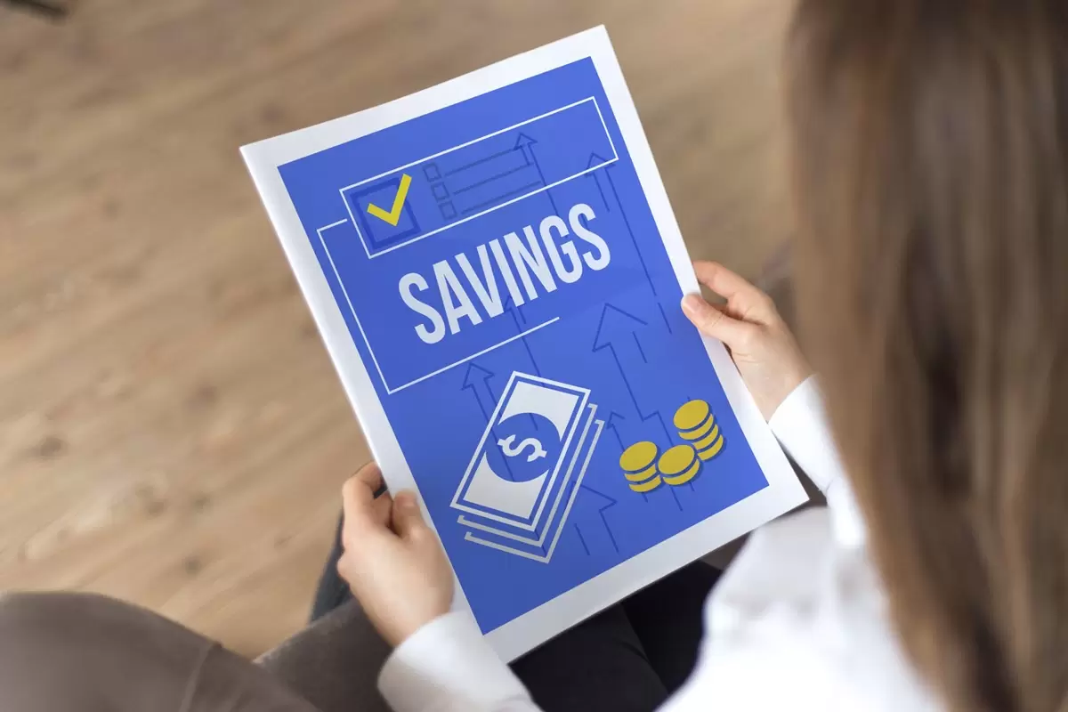 Woman reading savings account pamphlet.